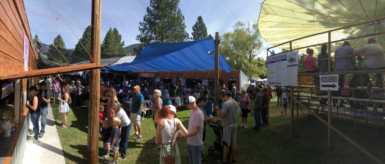 Panoramic view of Huckleberry Festival in Trout creek Montana with lots of people